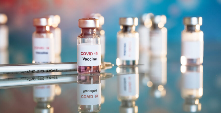 Eight small vials labeled COVID-19 vaccine