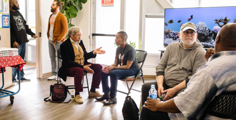 People sitting in a room talking in pairs