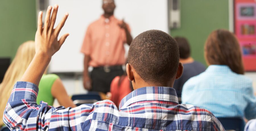 person raising hand classroom