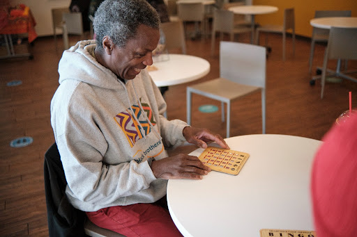 Black Brothers Esteem member seated at a table during a BBE social game night