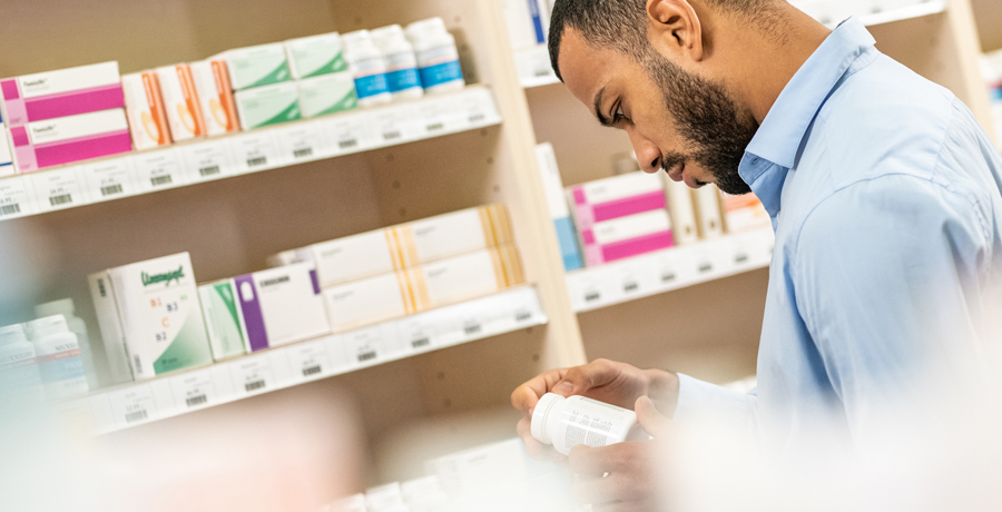 Pharmacist looking at medication bottle