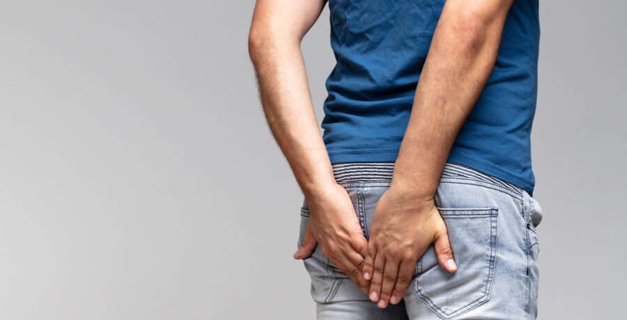 man holding his butt