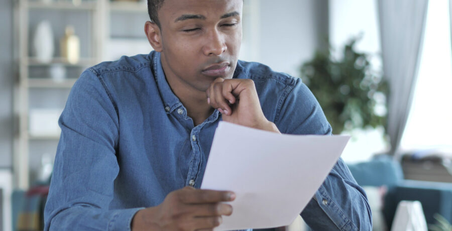 young man looking at paper