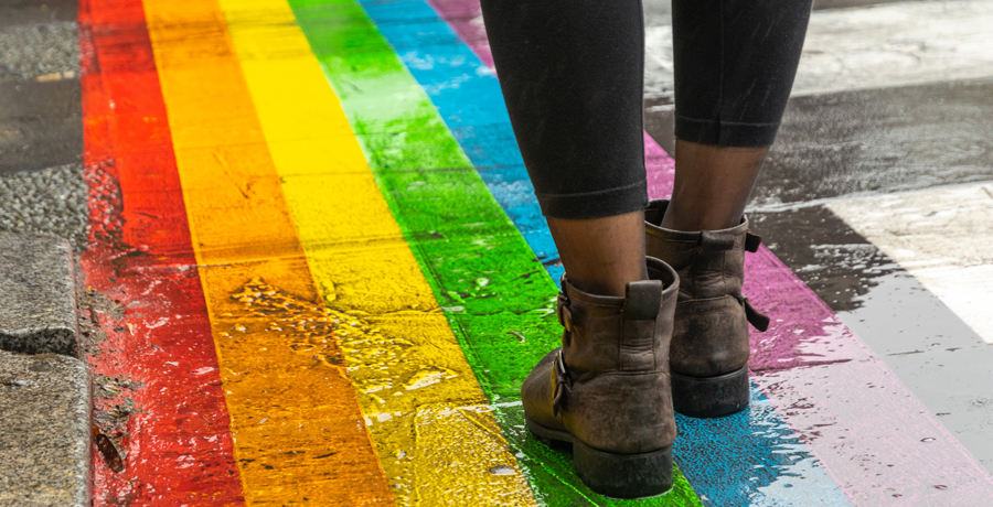 Person walking on rainbow sidewalk